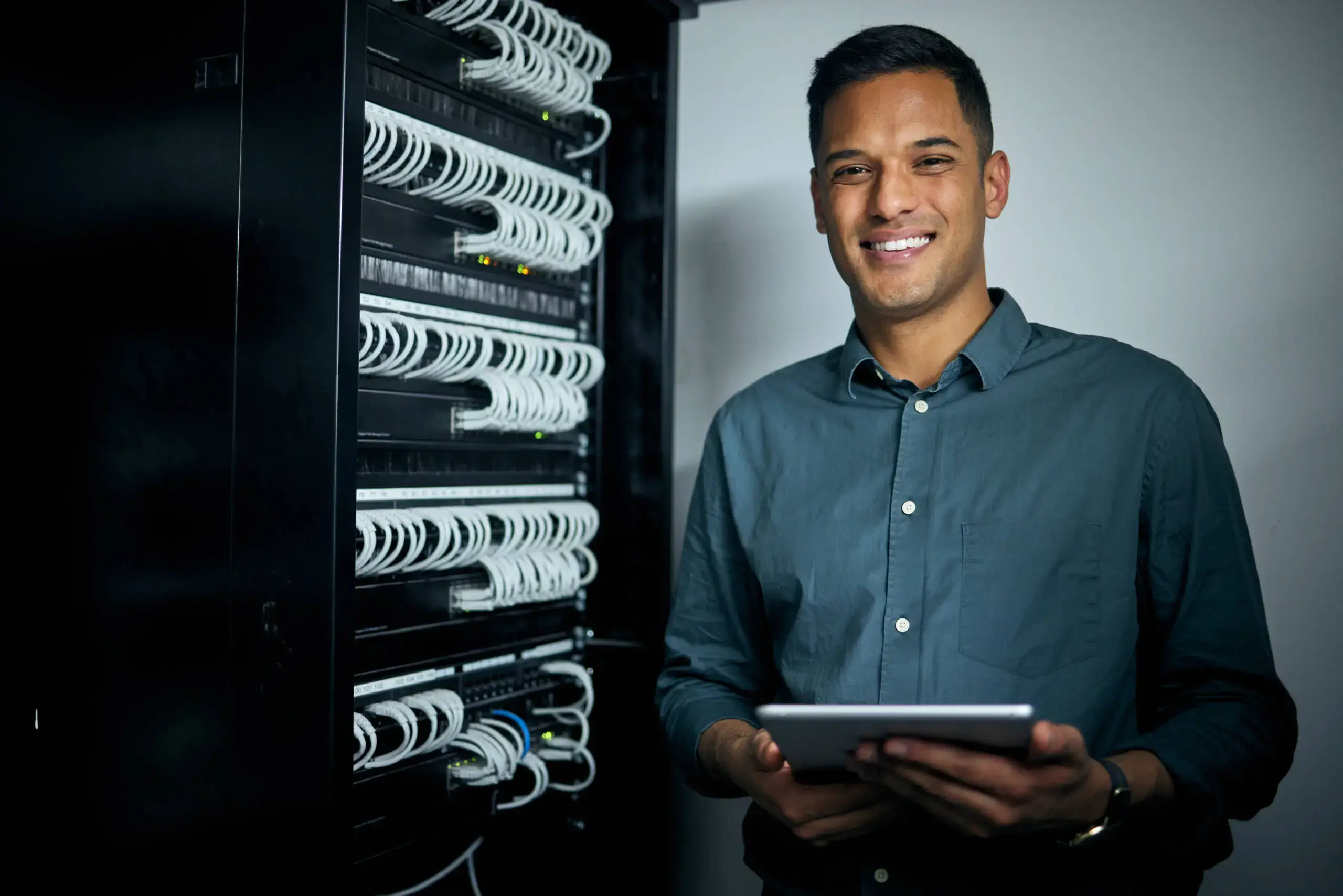 Engineer with a tablet in a server room